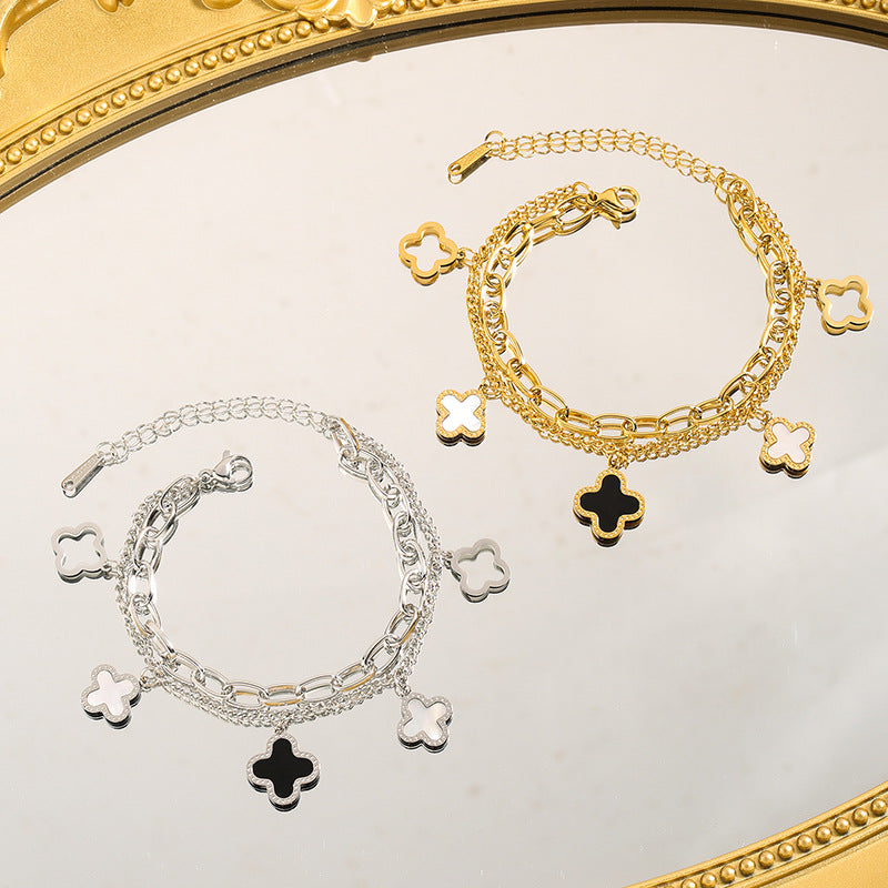 Double layered charm bracelet with clover and heart lucky symbols