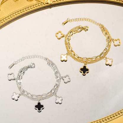 Double layered charm bracelet with clover and heart lucky symbols
