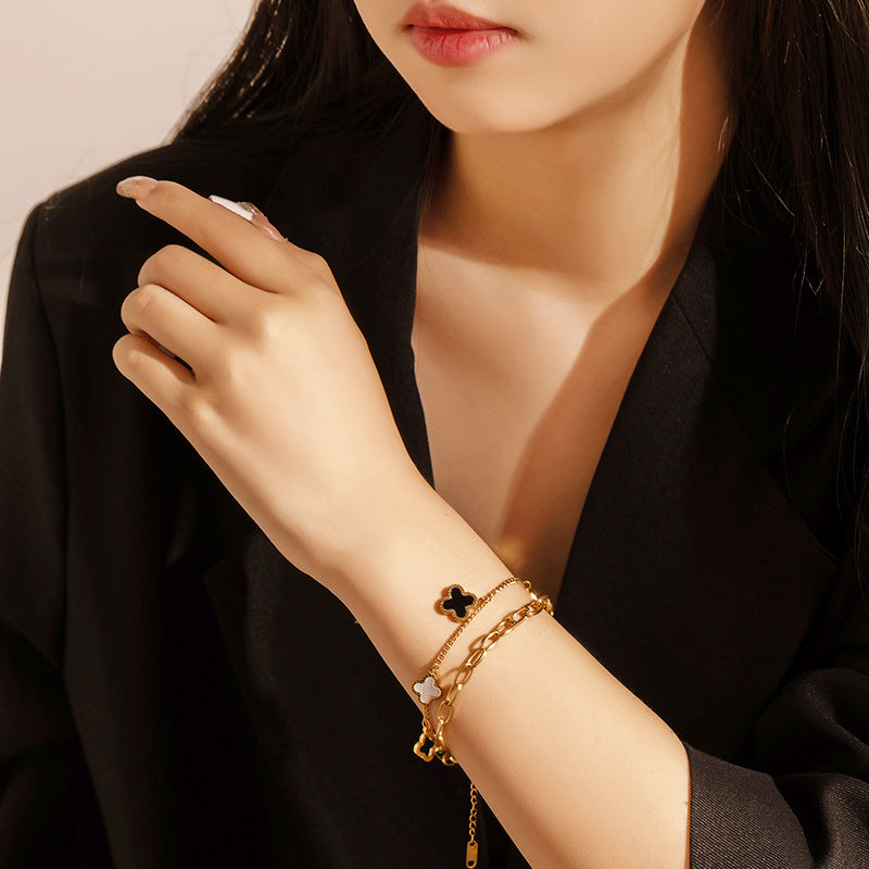 Double layered charm bracelet with clover and heart lucky symbols