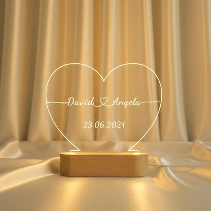 Custom engraved acrylic heart night light with couple names and date glowing warm led