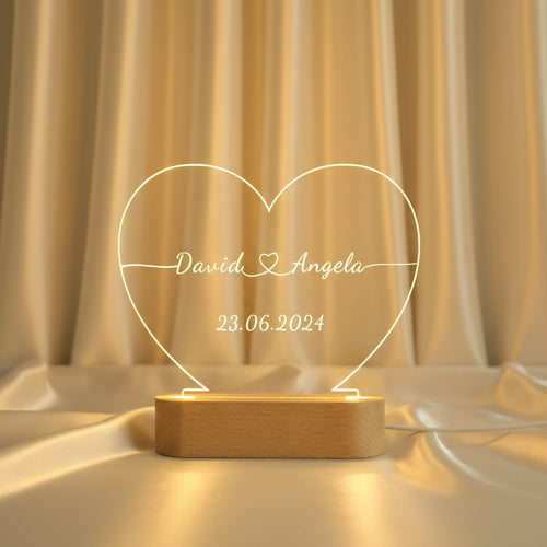 Custom engraved acrylic heart night light with couple names and date glowing warm led