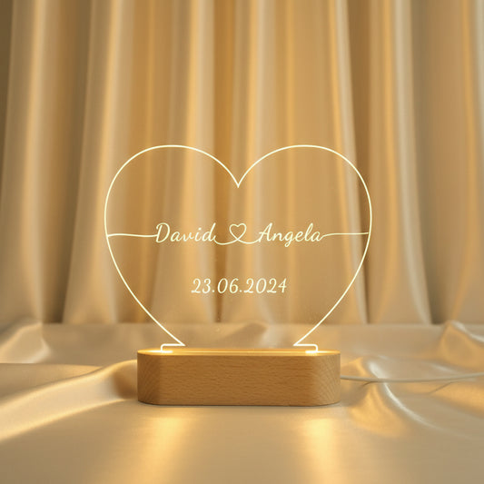Custom engraved acrylic heart night light with couple names and date glowing warm led